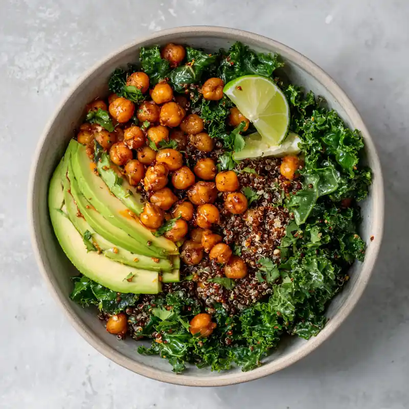 Simple quinoa harvest bowl with chickpeas, avocado, kale, and lemon dressing